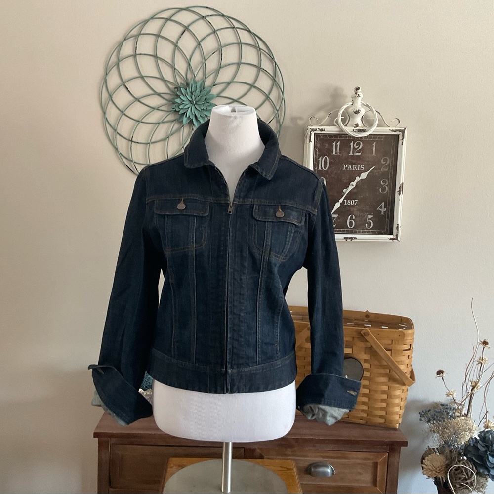 Dark wash Jean jacket. Zips up the front.